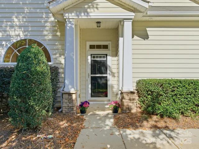 a front view of a house with a garden