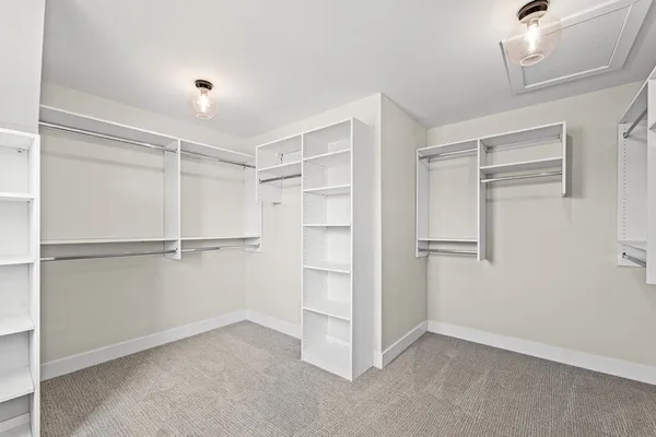 an empty room with a window and a ceiling fan