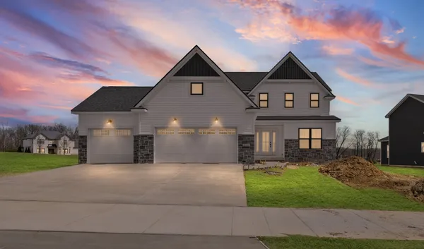 a front view of a house with a yard and garage