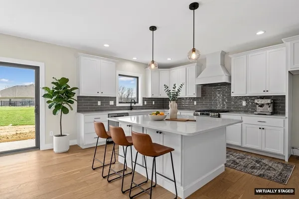 a kitchen with white cabinets and white appliances