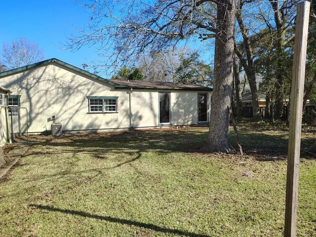 a view of a house with backyard and sitting area