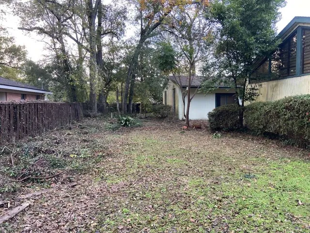 a backyard of a house with lots of green space