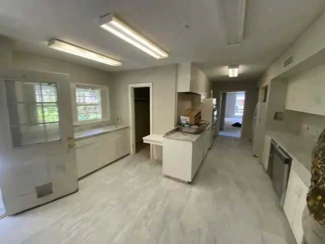 a view of a kitchen with a sink storage and utility room