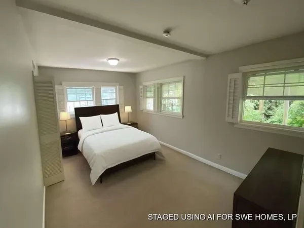 a bedroom with a bed and window