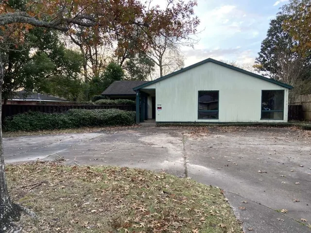 a house with trees in the background