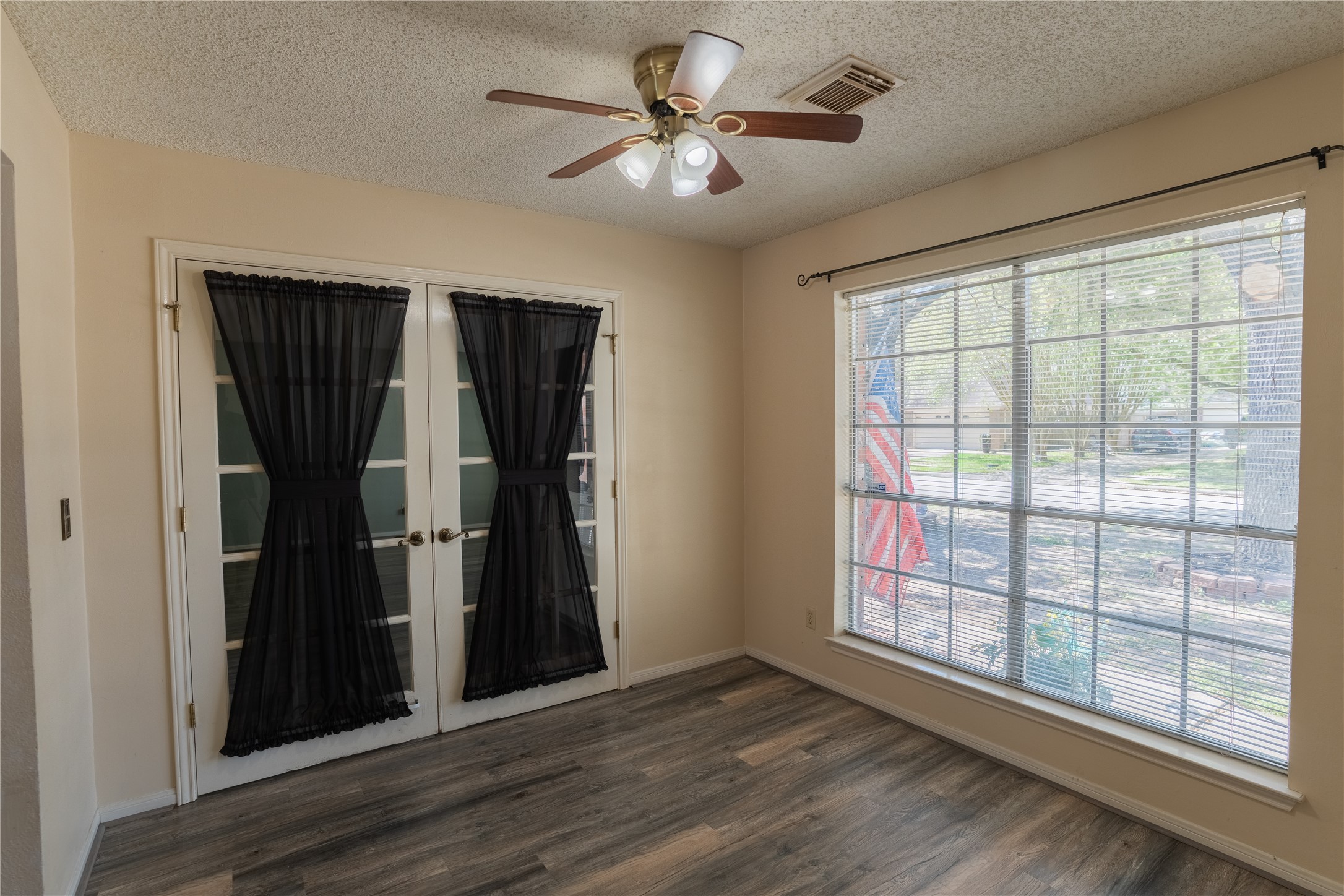 4007 Spring Forest Drive Pearland, TX 77584 - Photo 14 of 39 wooden floor in an empty room with a window