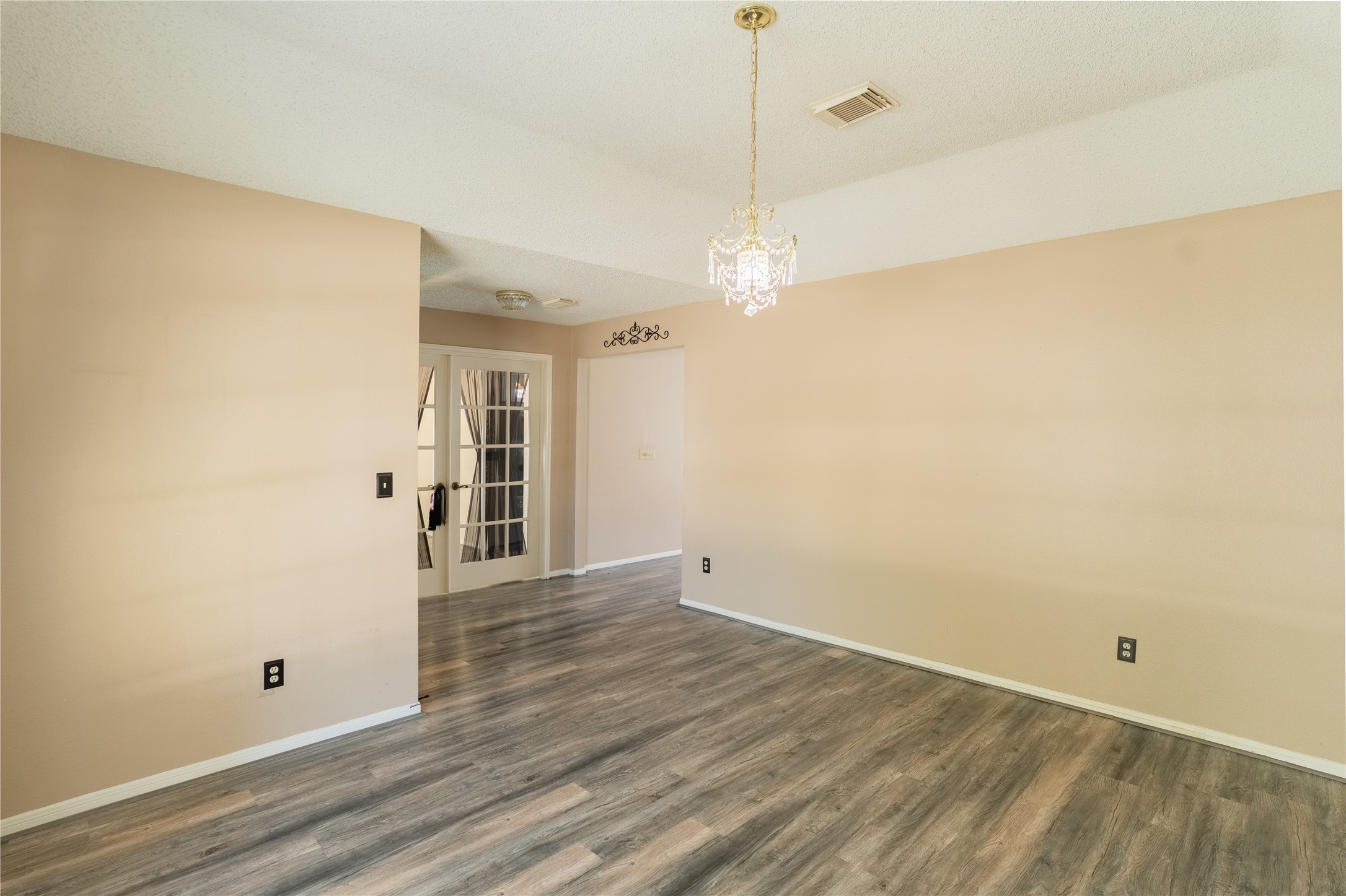 4007 Spring Forest Drive Pearland, TX 77584 - Photo 15 of 39 an empty room with wooden floor and windows