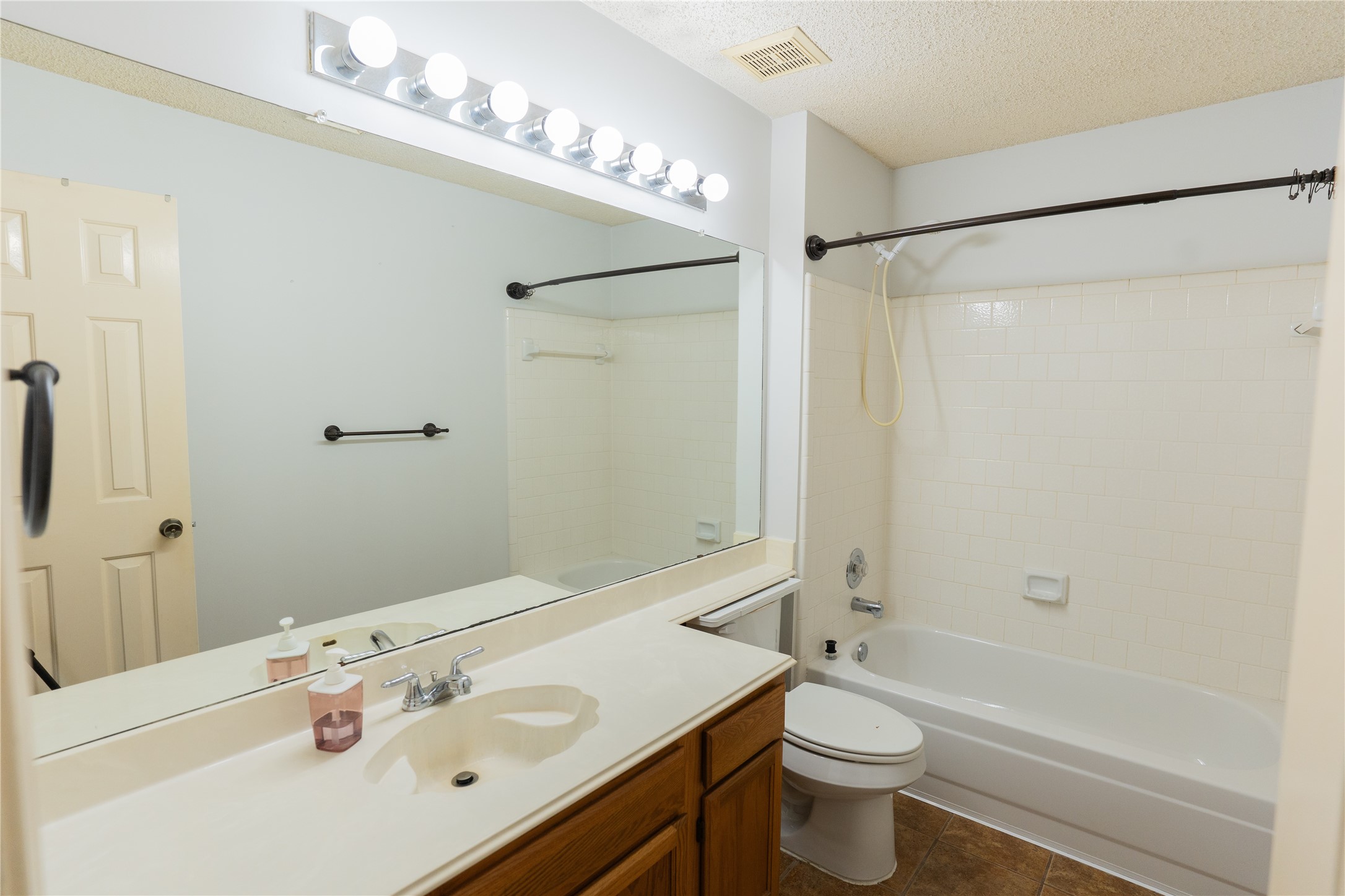 4007 Spring Forest Drive Pearland, TX 77584 - Photo 24 of 39 a bathroom with a sink a toilet a mirror and shower