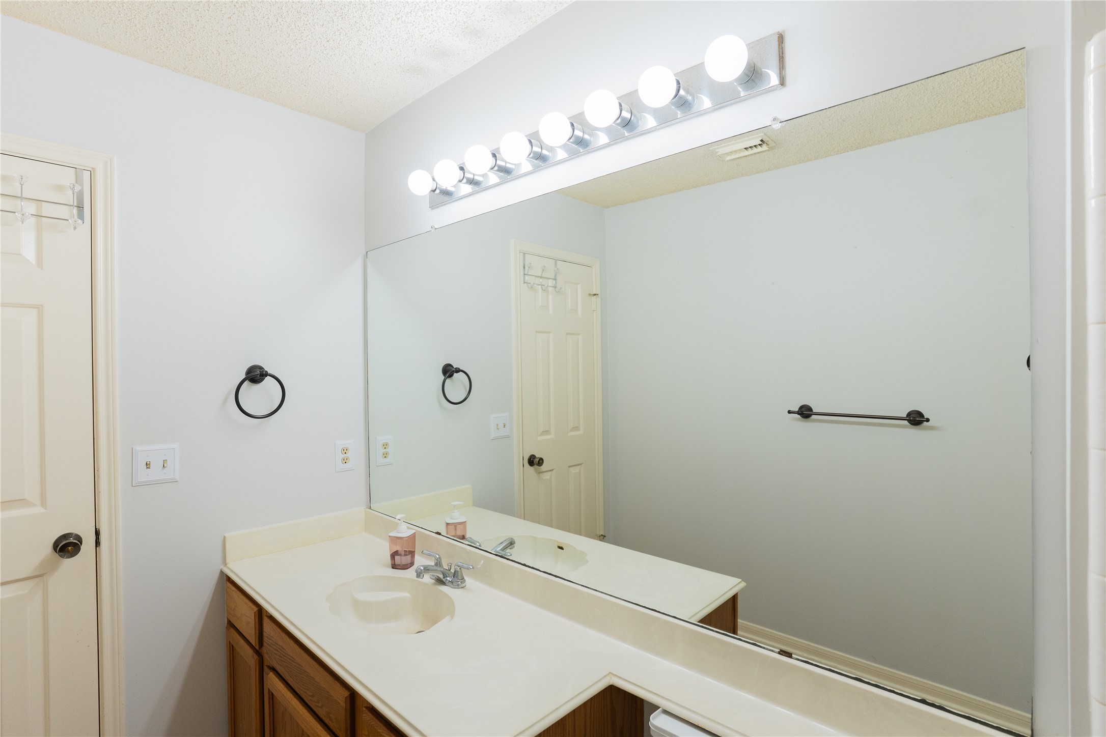 4007 Spring Forest Drive Pearland, TX 77584 - Photo 28 of 39 a bathroom with a sink vanity and a mirror
