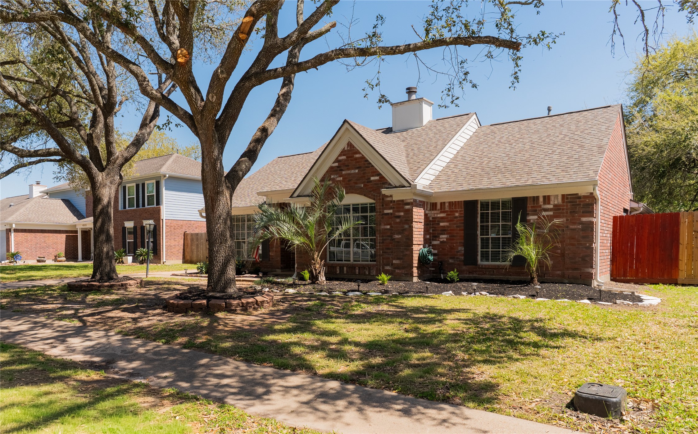 4007 Spring Forest Drive Pearland, TX 77584 - Photo 32 of 39 a view of a house with large windows and a tree