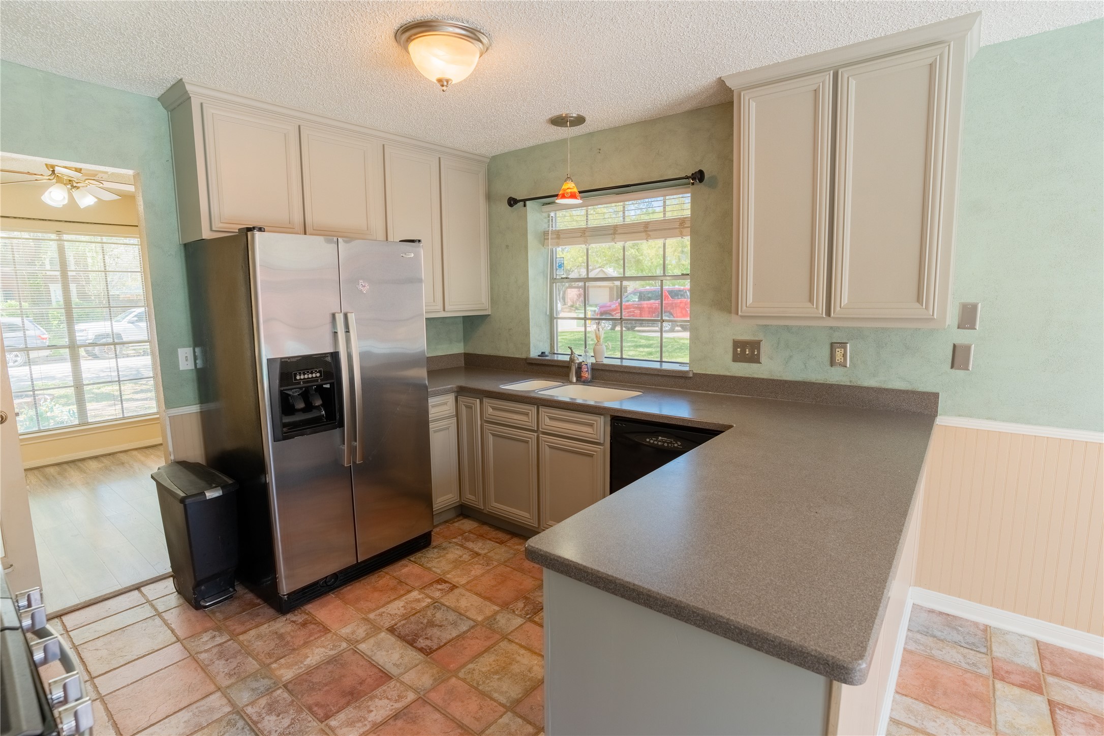 4007 Spring Forest Drive Pearland, TX 77584 - Photo 10 of 39 a kitchen with stainless steel appliances granite countertop a refrigerator a sink a stove a washer dryer and a window