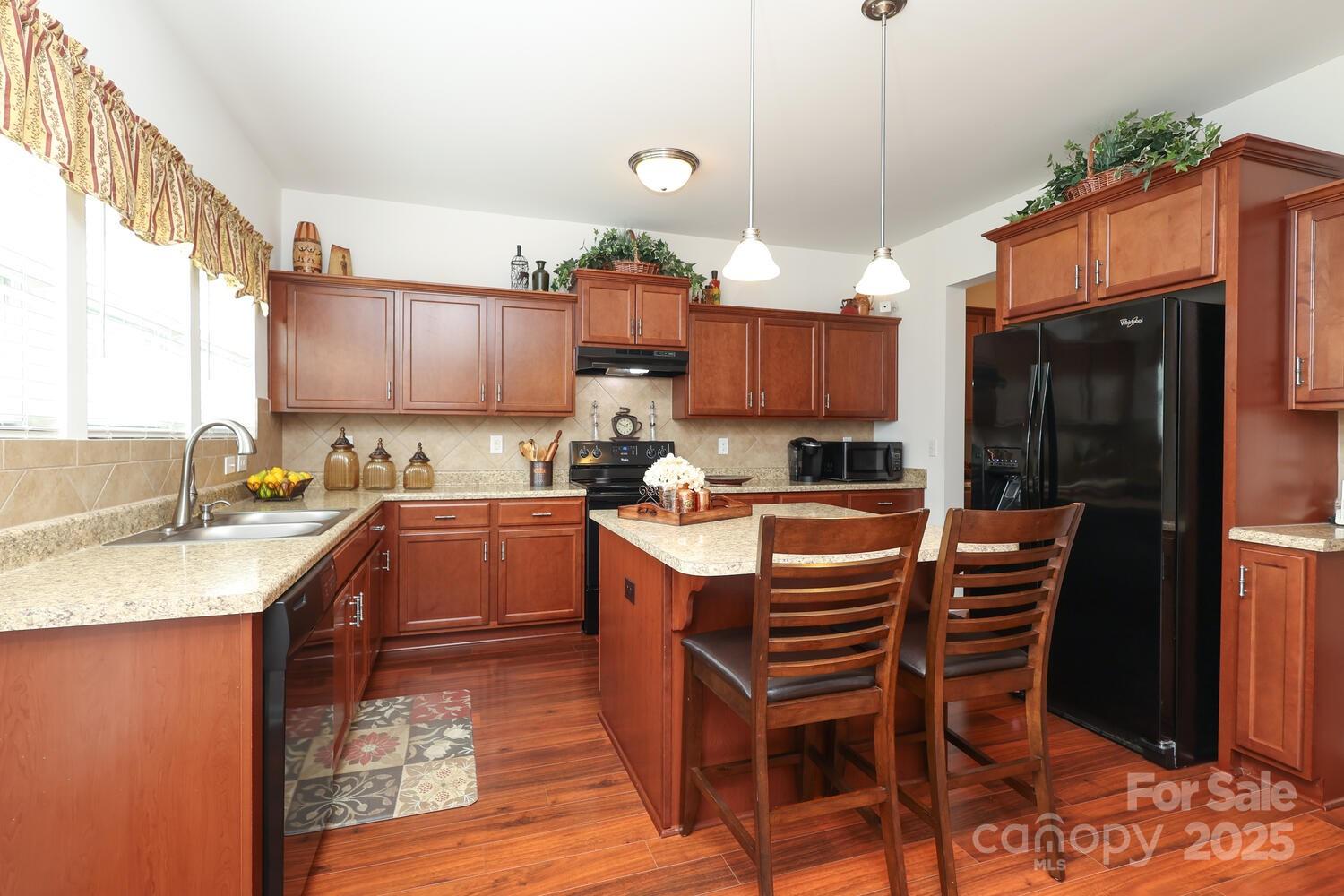 2104 Gillette Drive Clover, SC 29710 - Photo 14 of 33 a kitchen with stainless steel appliances granite countertop a stove a sink and a refrigerator