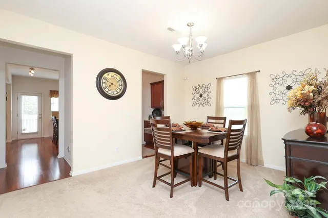a view of a dining room with furniture and chandelier