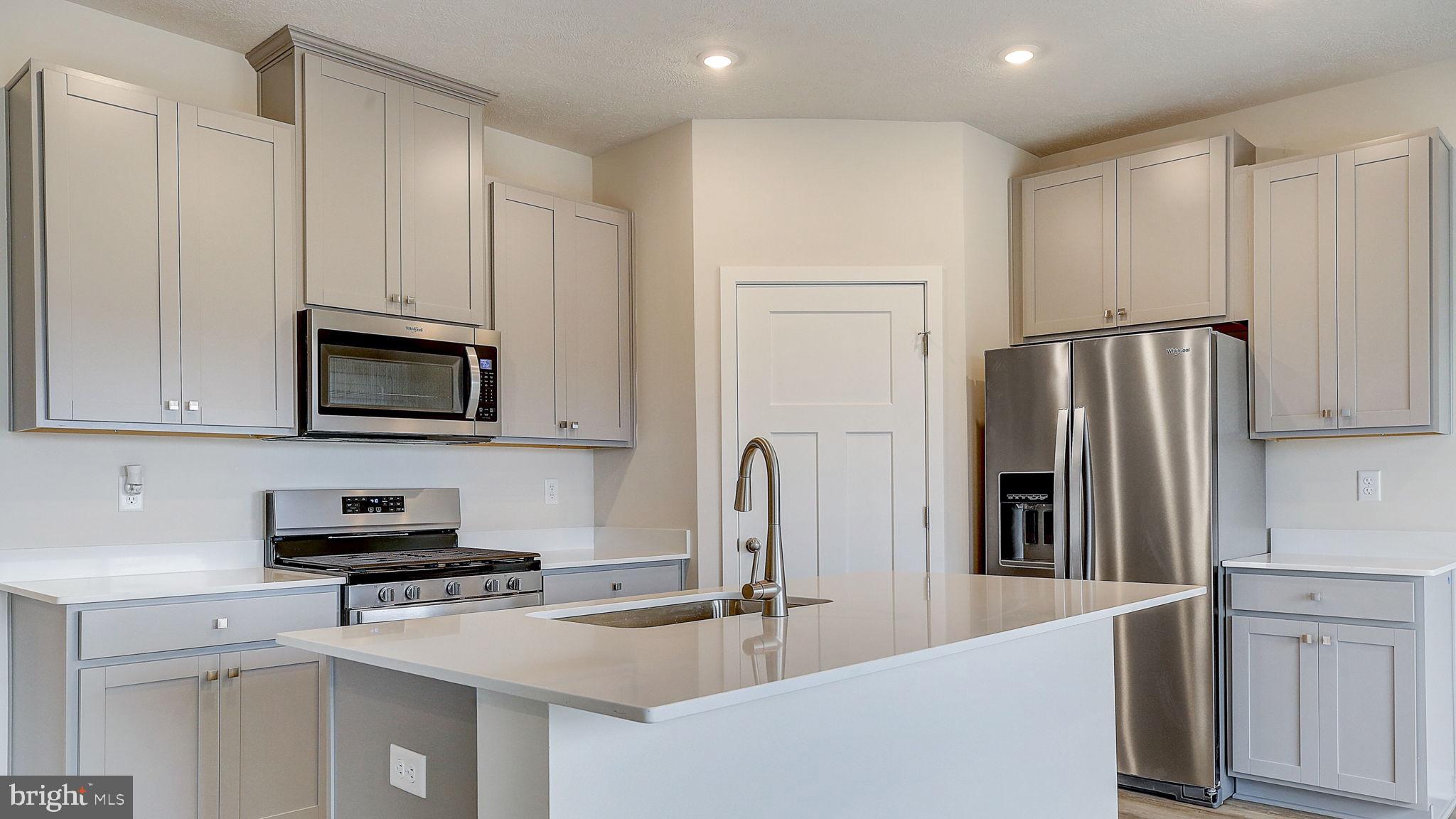 116 Erica Lane Columbia, PA 17512 - Photo 6 of 8 a kitchen with stainless steel appliances granite countertop a refrigerator sink and stove