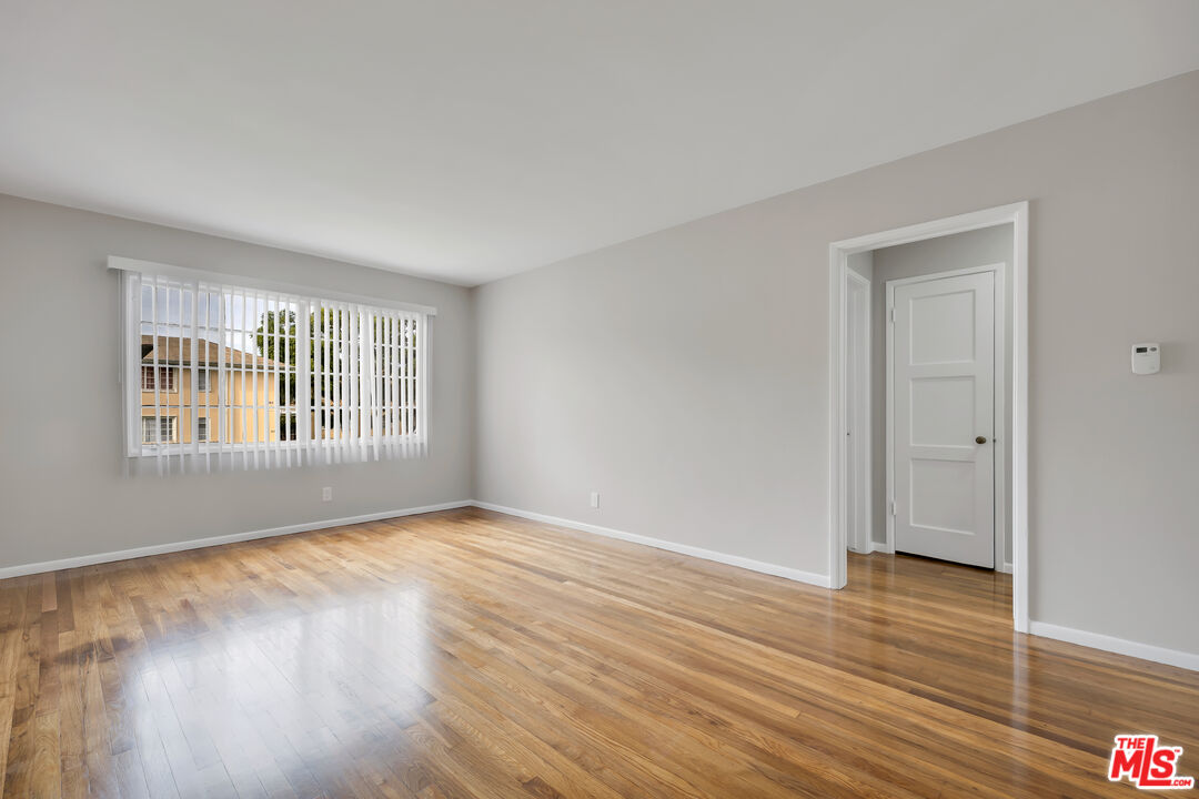 4086 Abourne Road, Unit A Los Angeles, CA 90008 - Photo 14 of 36 a view of an empty room with wooden floor and a window