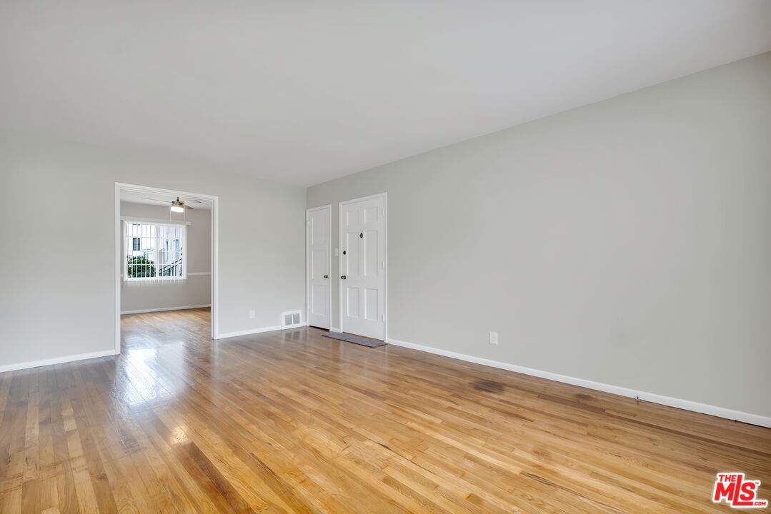 4086 Abourne Road, Unit A Los Angeles, CA 90008 - Photo 16 of 36 a view of an empty room with wooden floor and a window