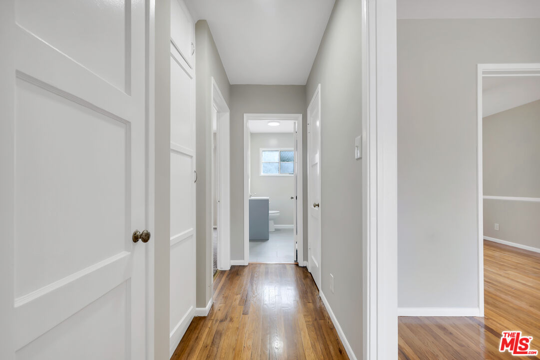 4086 Abourne Road, Unit A Los Angeles, CA 90008 - Photo 21 of 36 a view of a hallway with wooden floor and a bathroom