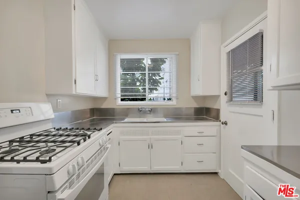 a kitchen with sink and cabinets