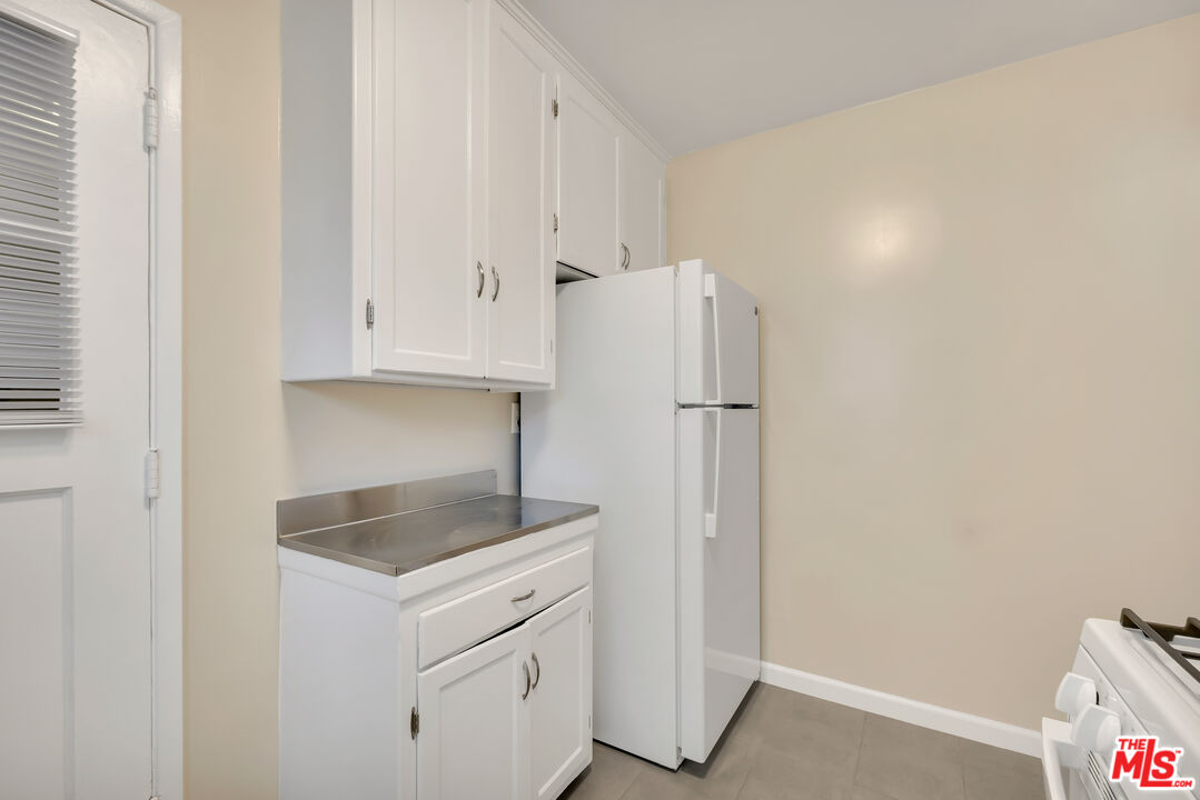4086 Abourne Road, Unit A Los Angeles, CA 90008 - Photo 31 of 36 a kitchen with cabinets and a refrigerator