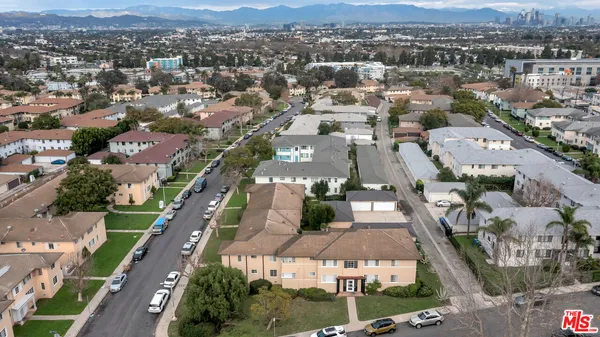an aerial view of residential houses with city view
