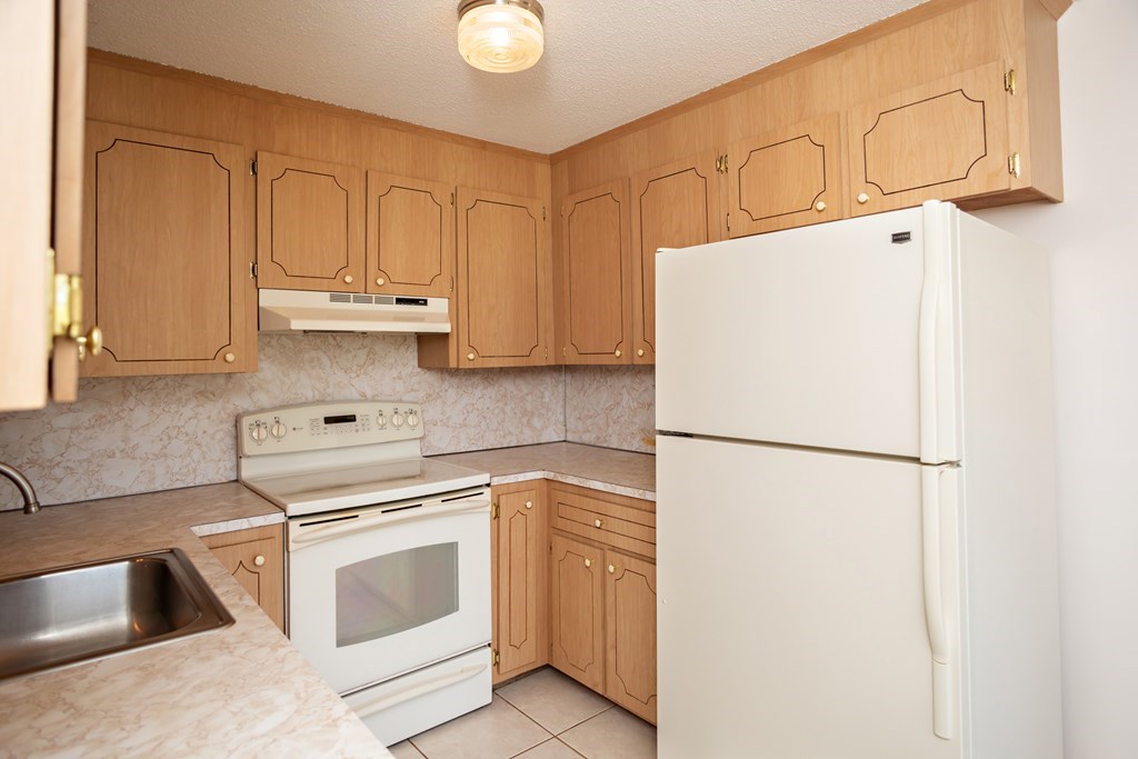 7 Susan Road, Unit 4 Wareham, MA 02532 - Photo 9 of 26 a white refrigerator freezer sitting inside of a kitchen