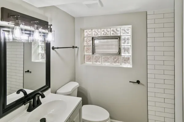 a bathroom with a toilet sink and shower