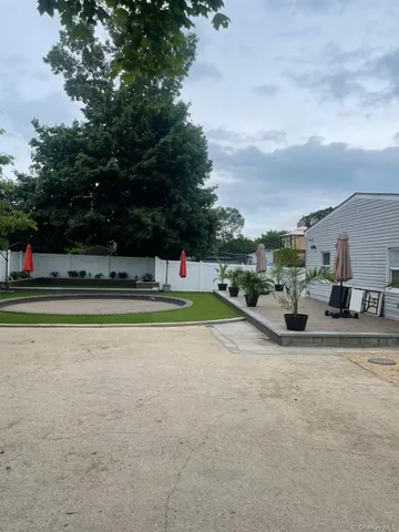 a view of a chairs and table in backyard