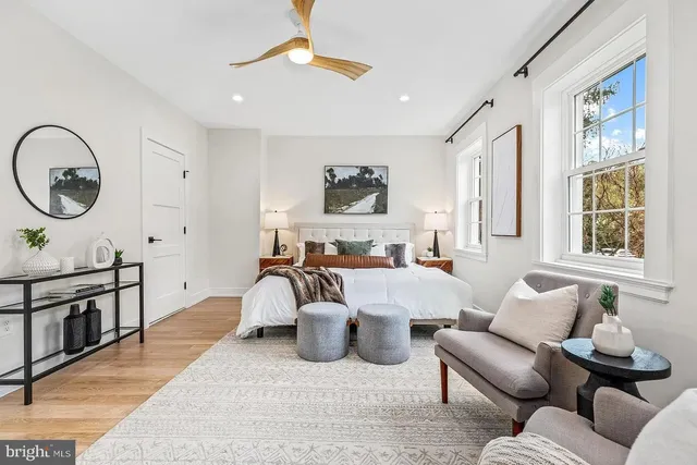 a living room with furniture a window and a chandelier