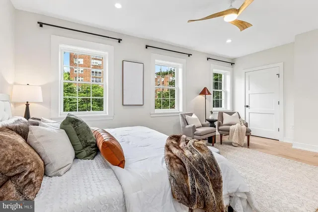 a bedroom with two beds and a window