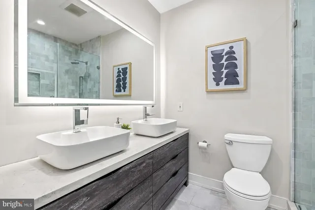 a bathroom with a toilet a sink and mirror