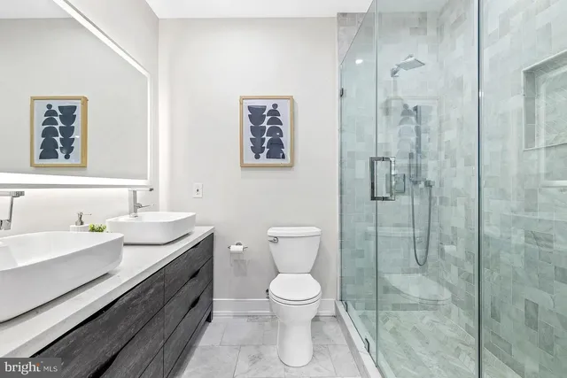a bathroom with a toilet a sink and glass door