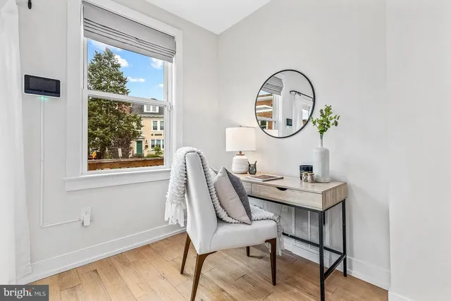 a view of a dining room with furniture window and wooden floor