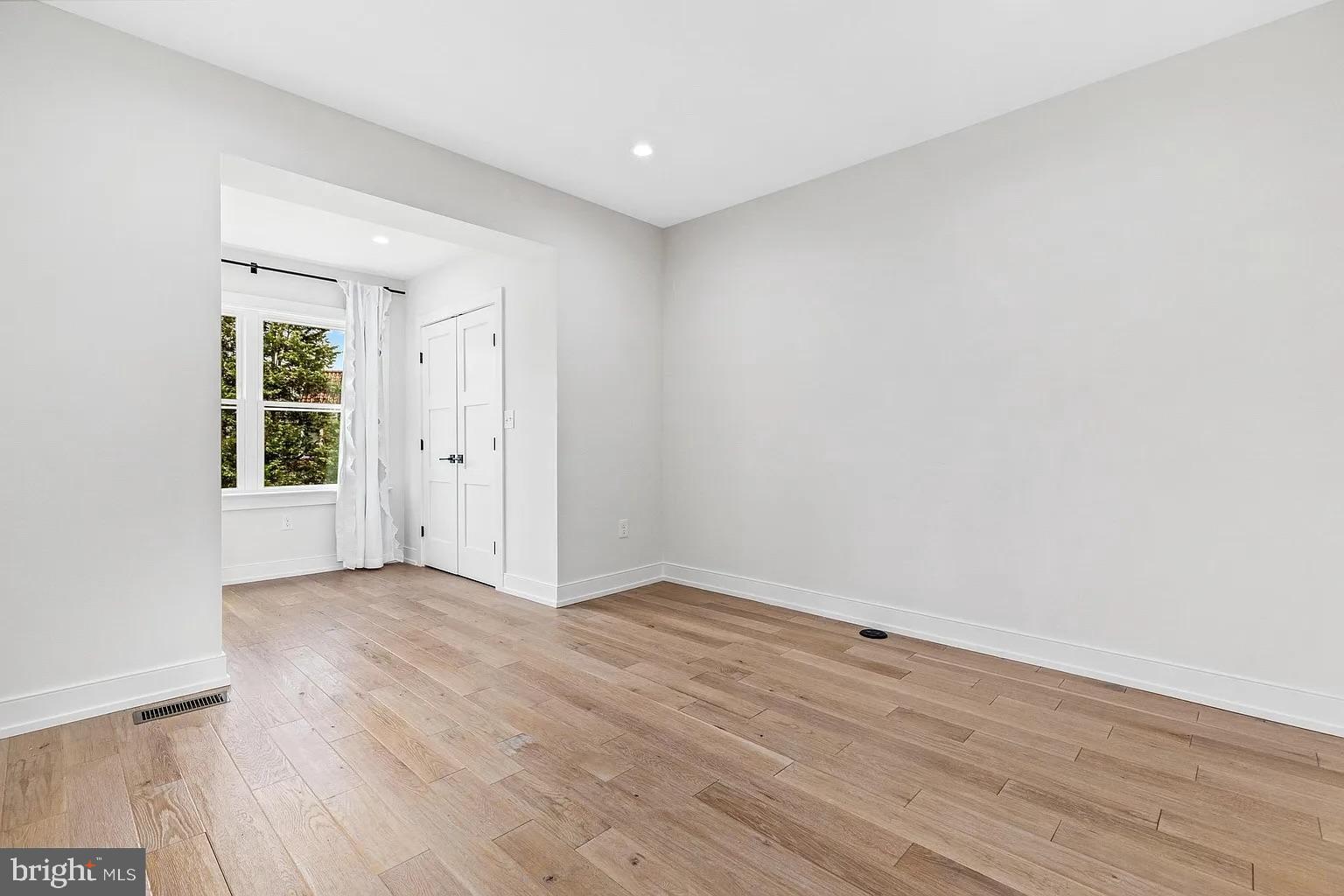 3525 16th Street Northwest Washington, DC 20010 - Photo 22 of 38 an empty room with wooden floor and windows