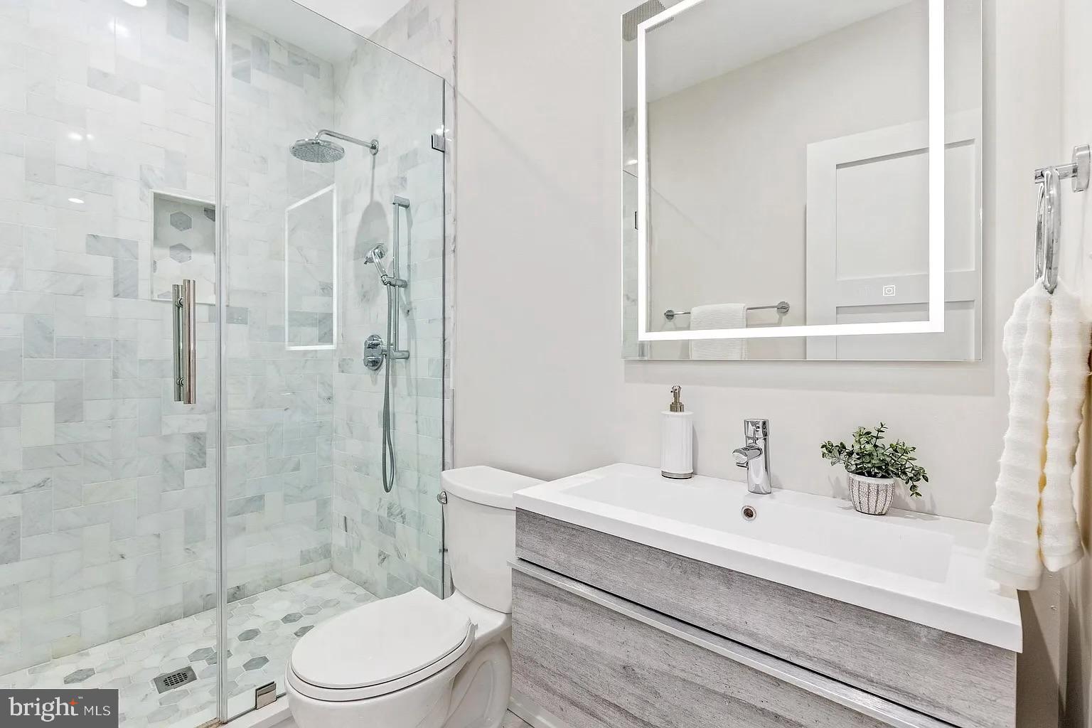 3525 16th Street Northwest Washington, DC 20010 - Photo 23 of 38 a bathroom with a sink a toilet and shower