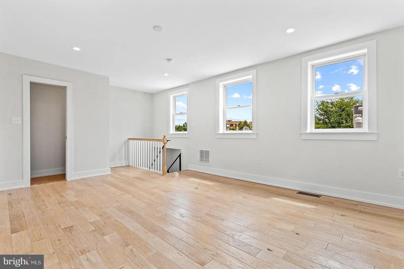 3525 16th Street Northwest Washington, DC 20010 - Photo 25 of 38 a view of an empty room with wooden floor and a window