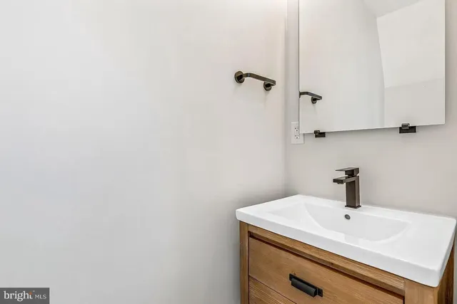a bathroom with a sink and mirror