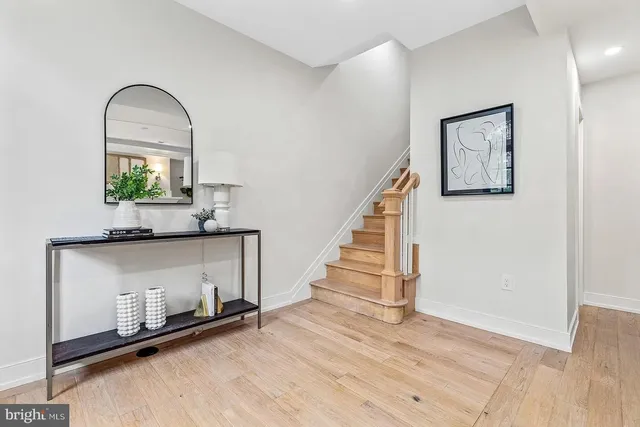 a view of entryway and hall with wooden floor