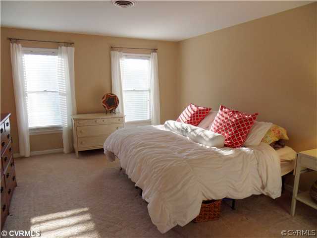 5425 Standing Oak Road Midlothian, VA 23112 - Photo 11 of 18 a bed sitting in a bedroom next to a window