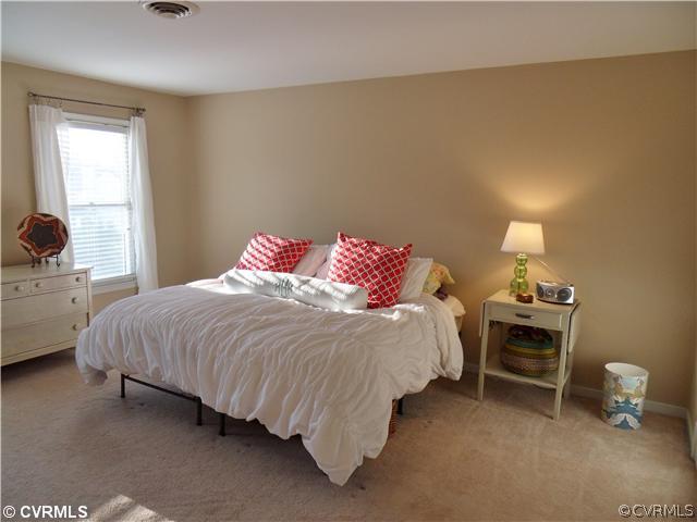 5425 Standing Oak Road Midlothian, VA 23112 - Photo 12 of 18 a bedroom with a bed and a lamp