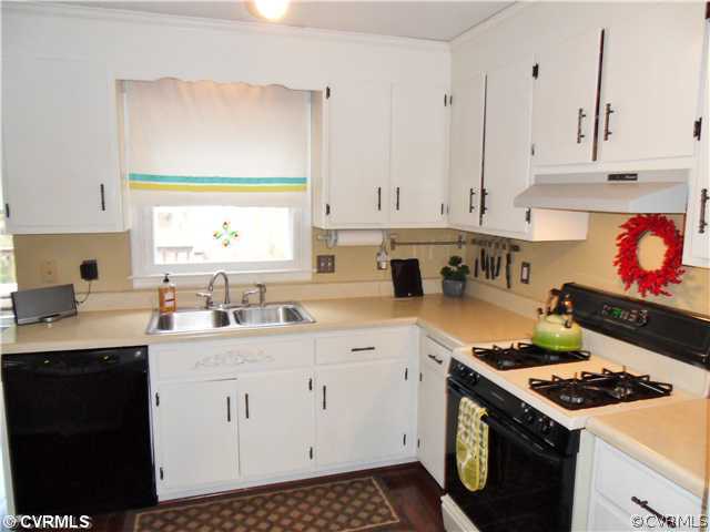 5425 Standing Oak Road Midlothian, VA 23112 - Photo 8 of 18 a kitchen with stainless steel appliances a stove a sink and a cabinets