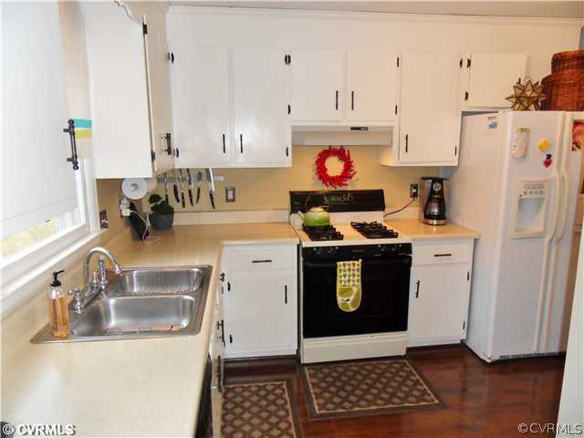 5425 Standing Oak Road Midlothian, VA 23112 - Photo 9 of 18 a kitchen with stainless steel appliances a stove a sink and a refrigerator with wooden floor