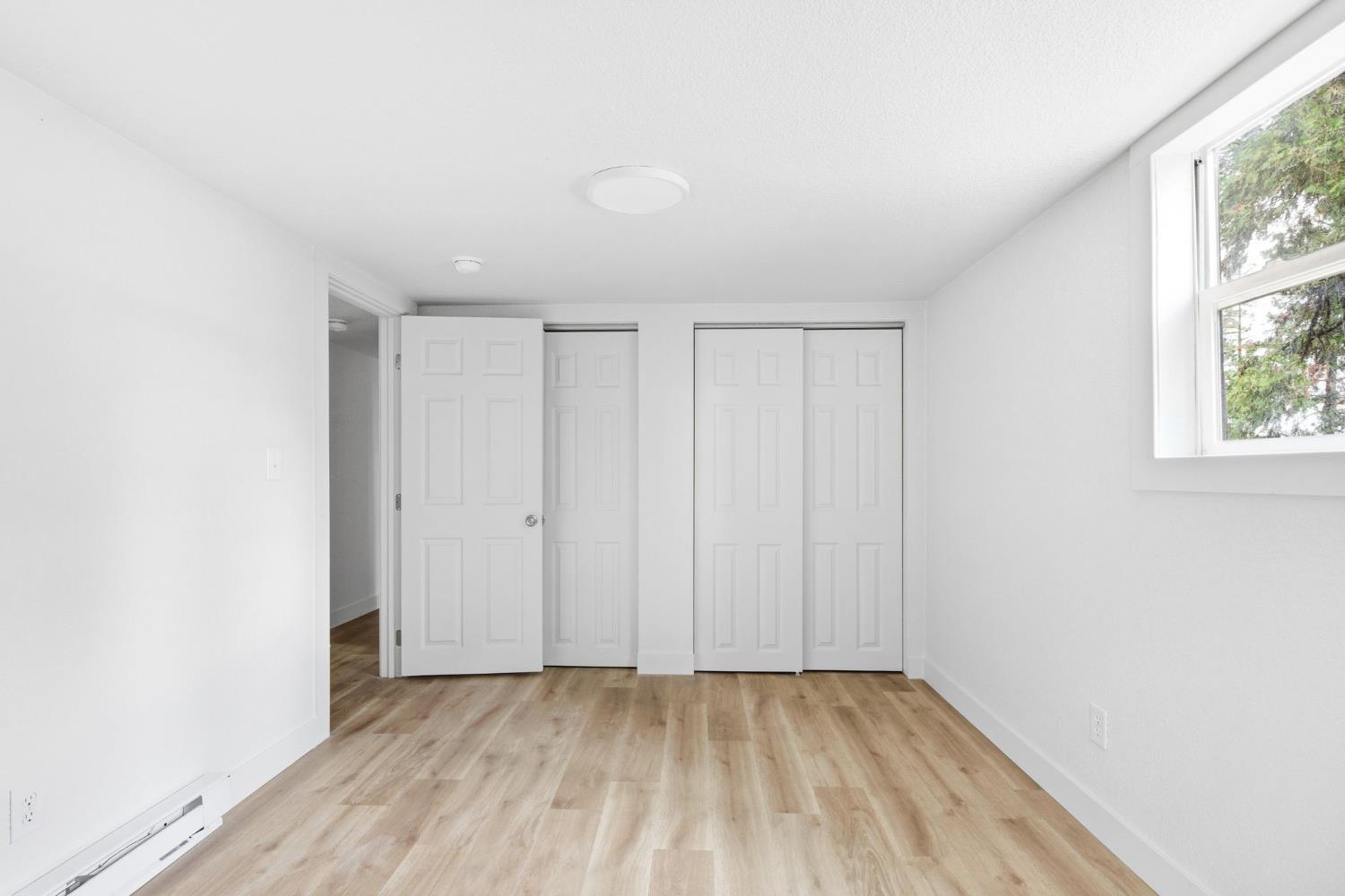 19159 Allan Road Volcano, CA 95689 - Photo 12 of 27 a view of an empty room with wooden floor and a window
