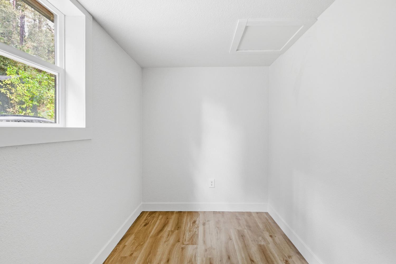 19159 Allan Road Volcano, CA 95689 - Photo 16 of 27 a view of a small space with wooden floor and a window