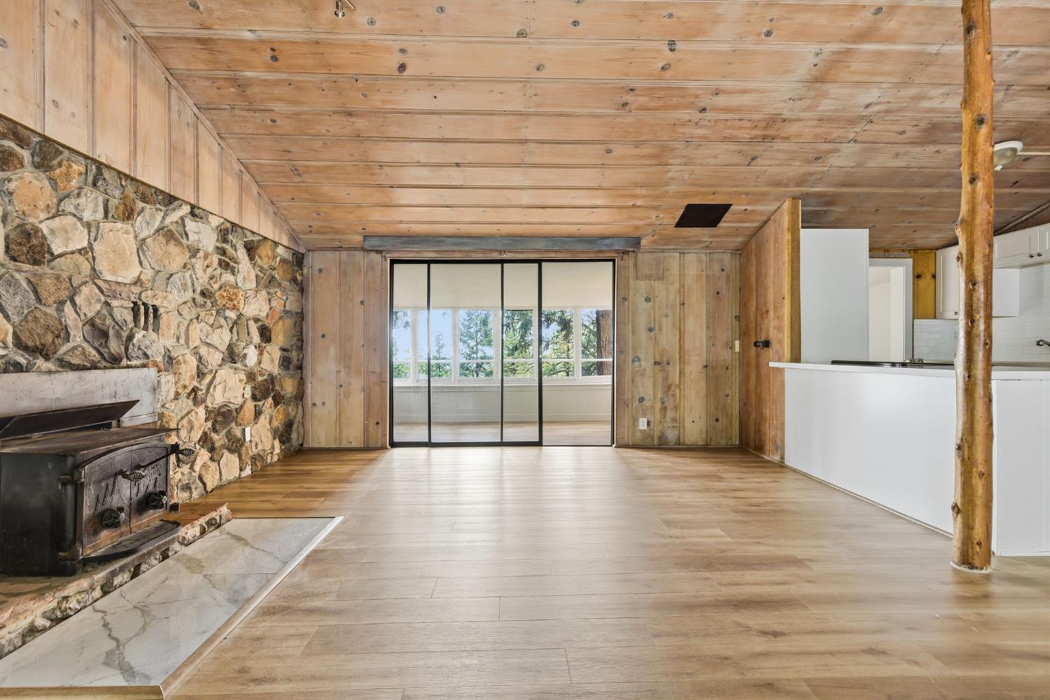 19159 Allan Road Volcano, CA 95689 - Photo 3 of 27 a view of empty room with wooden floor and fireplace