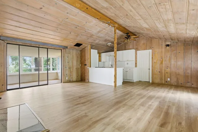 a view of a room with wooden floor