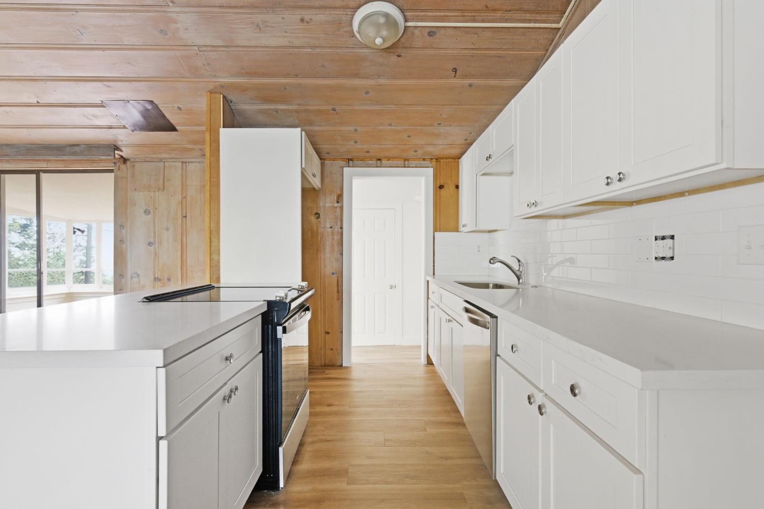 19159 Allan Road Volcano, CA 95689 - Photo 8 of 27 a large white kitchen with a large window