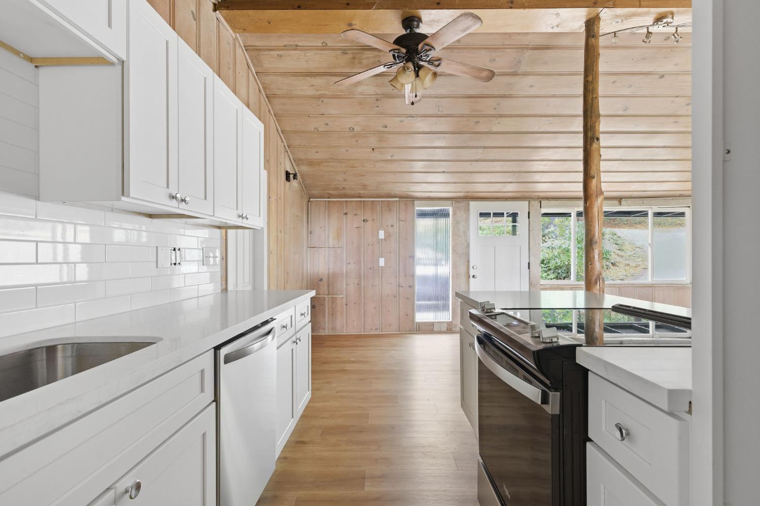 19159 Allan Road Volcano, CA 95689 - Photo 9 of 27 a kitchen with granite countertop a sink and a stove
