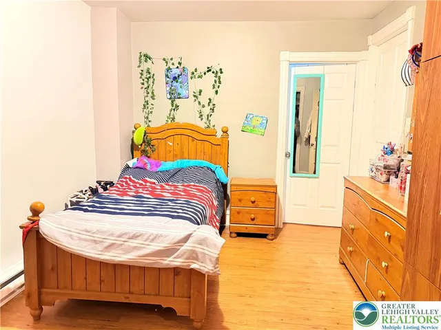a bedroom with a bed and a dresser