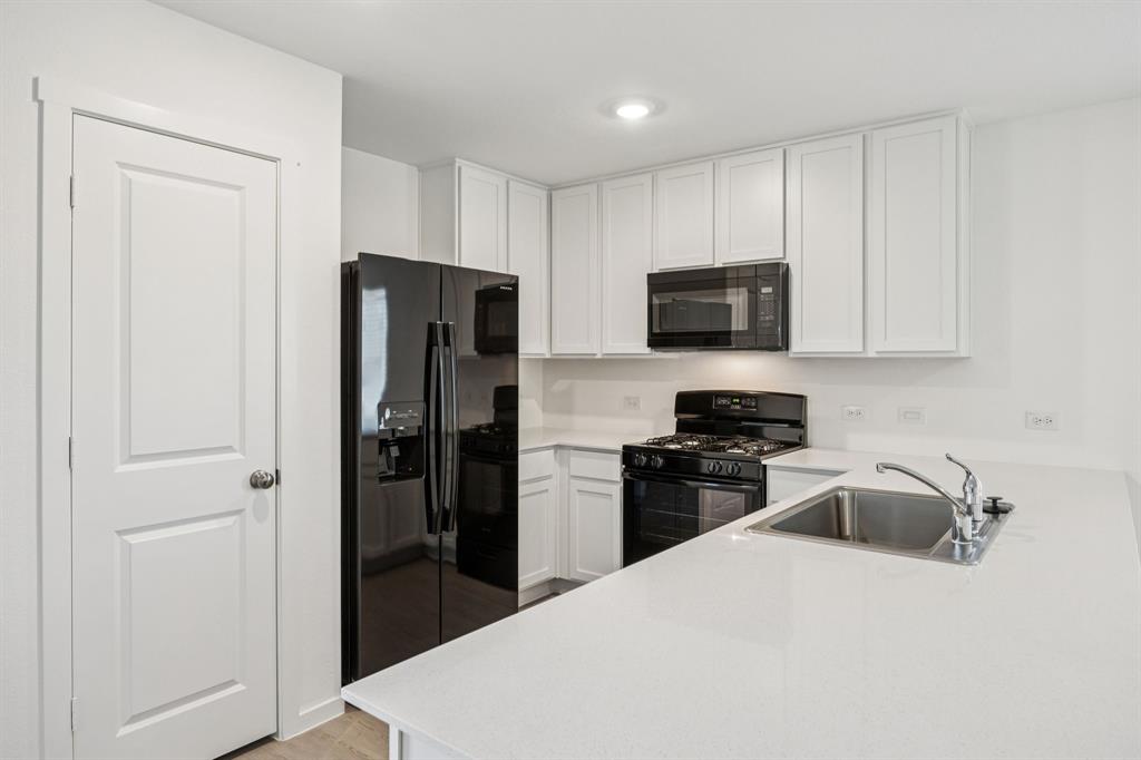 11550 Gammon Avenue Rhome, TX 76078 - Photo 11 of 29 a kitchen with stainless steel appliances granite countertop a refrigerator stove a sink and dishwasher