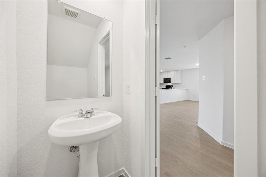 11550 Gammon Avenue Rhome, TX 76078 - Photo 14 of 29 a bathroom with a sink and a mirror